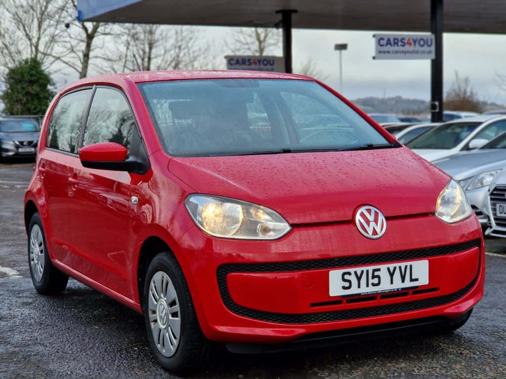 Red Volkswagen Up Car Parked Wallpaper