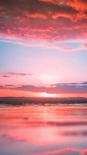 Relaxing At The Beach With A Beautiful Pink Aesthetic Wallpaper