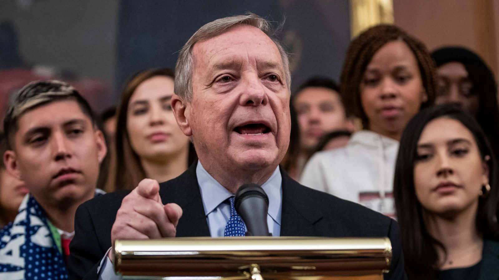 Richard Durbin Speaking At Podium Wallpaper