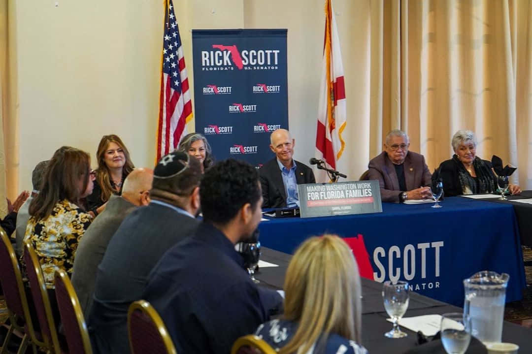 Rick Scott Facilitating Roundtable Discussion Wallpaper