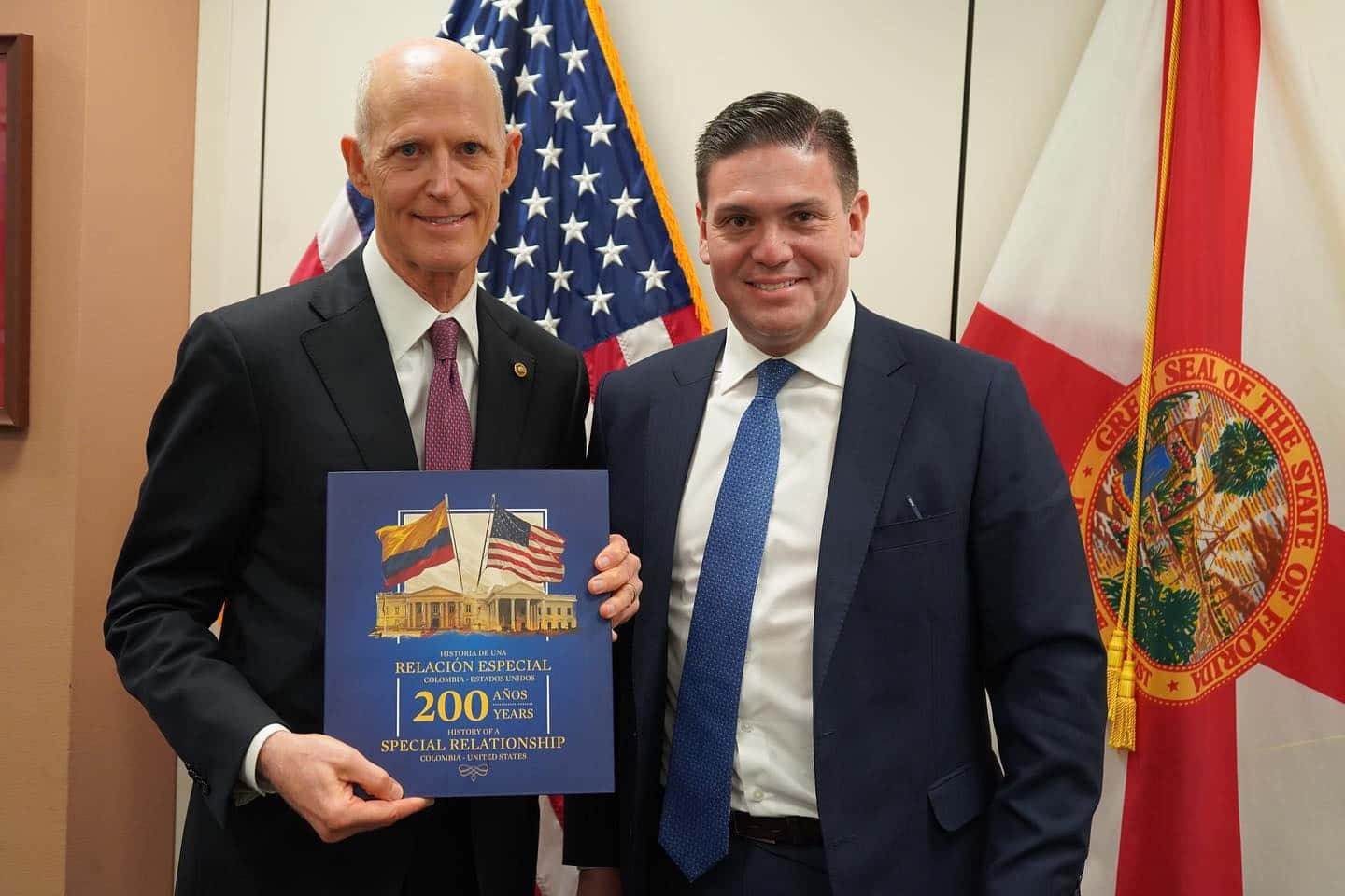 Rick Scott Holding Colombia Relations Commemoration Plaque Wallpaper