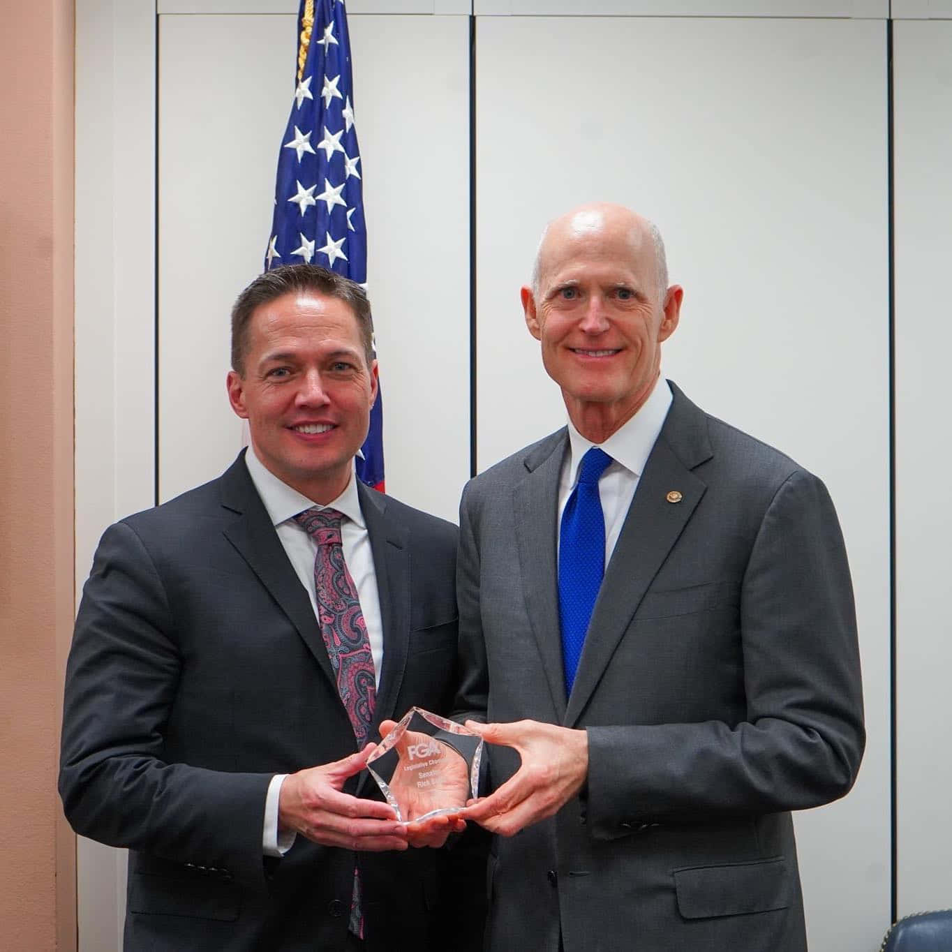 Rick Scott Proudly Holding A Trophy Award Wallpaper