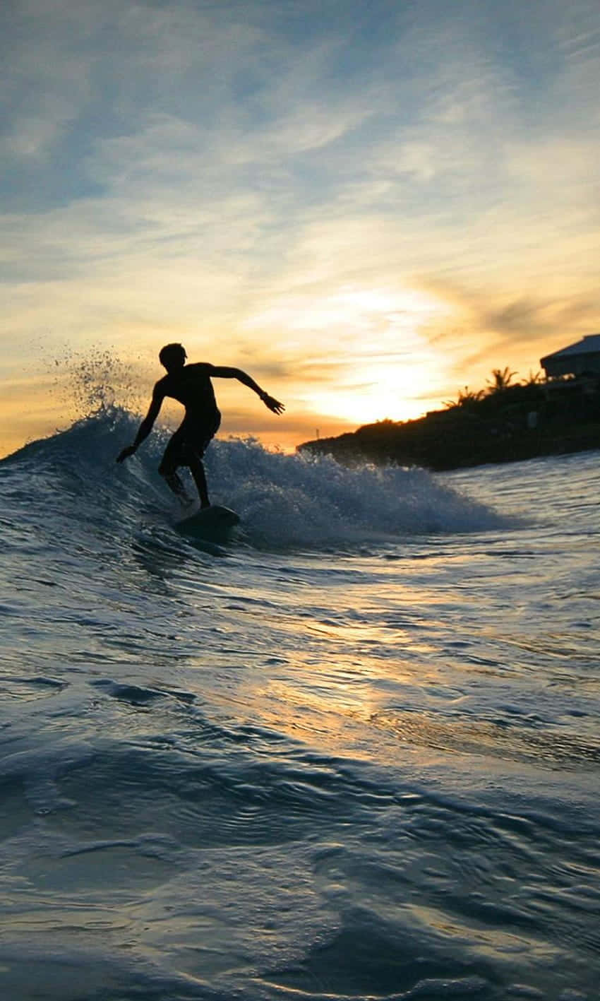 Ride The Waves With This Epic Surfing Iphone Wallpaper Wallpaper