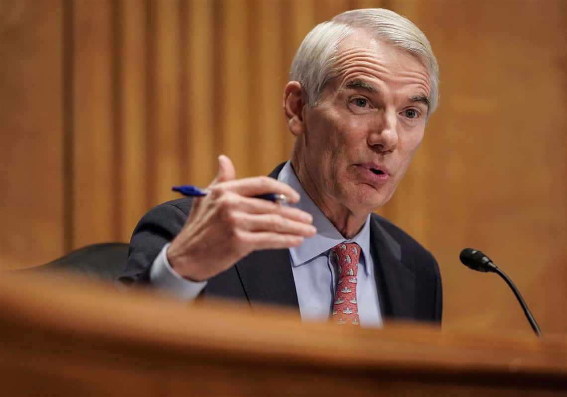 Rob Portman Addressing The Audience From A Podium Wallpaper