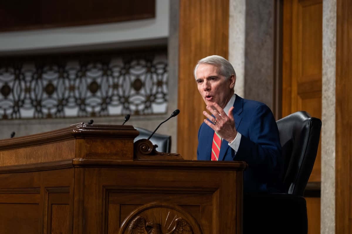 Rob Portman Speaking From Podium Wallpaper