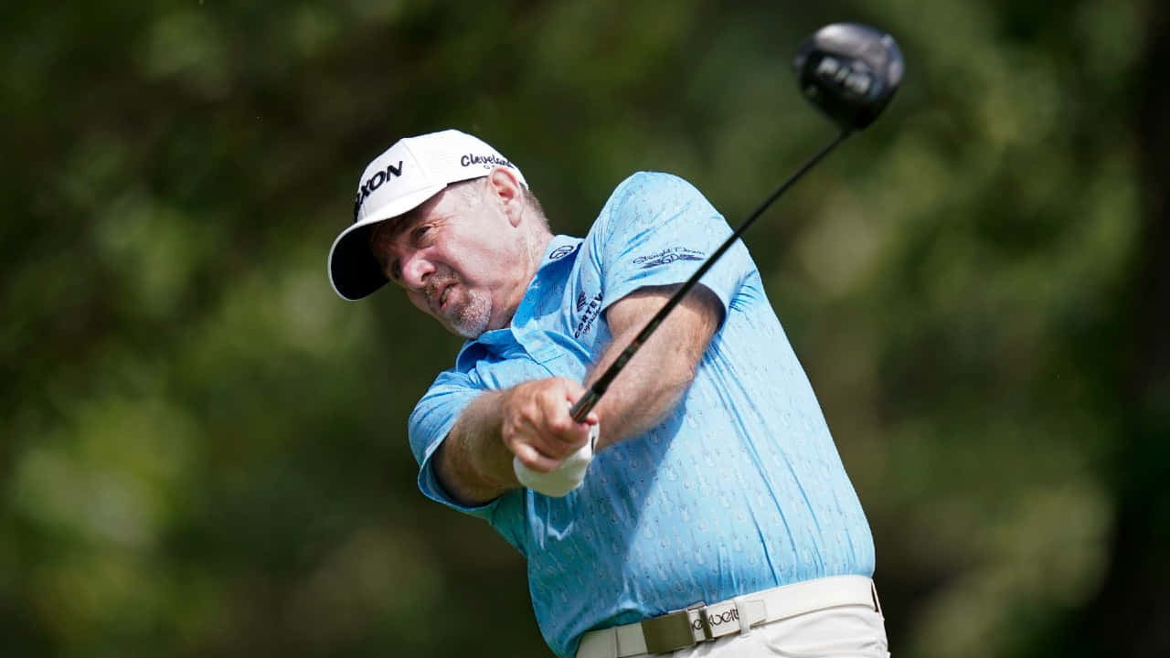 Rod Pampling Delivers A Powerful Swing In Blue Shirt Wallpaper