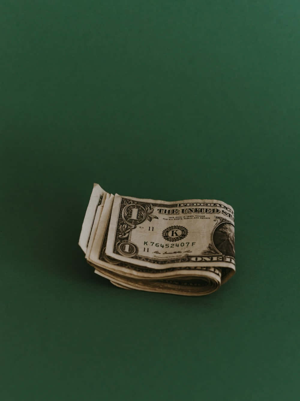 Rolled Dollar Bills Green Backdrop Wallpaper