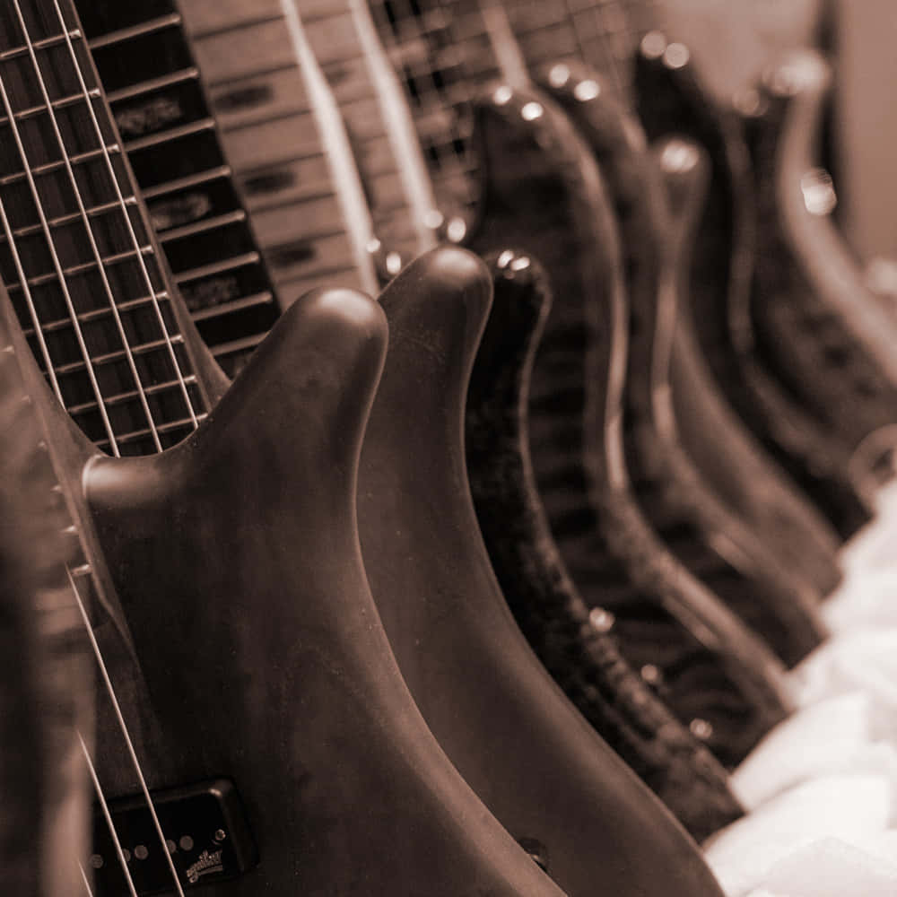 Rowof Bass Guitars Sepia Tone Wallpaper