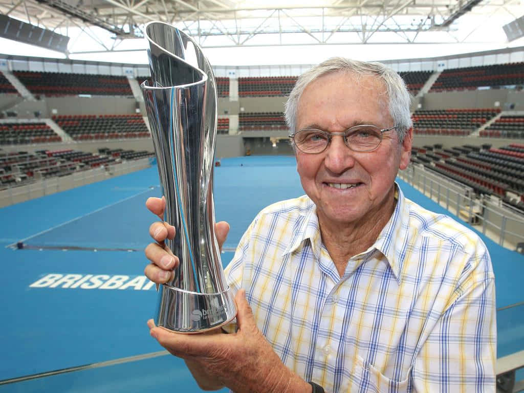 Roy Emerson Holding Trophyat Brisbane Tennis Court Wallpaper