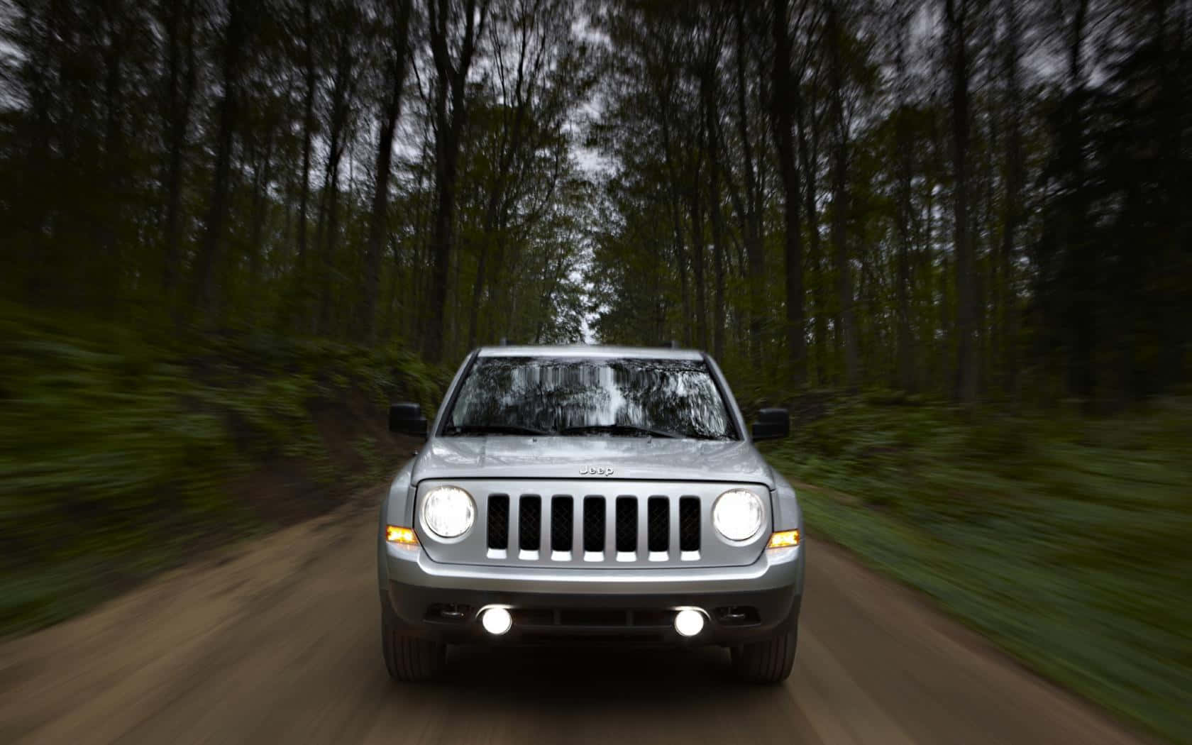 Rugged Jeep Patriot On A Scenic Mountain Adventure Wallpaper