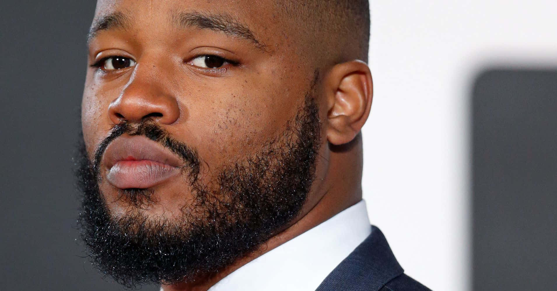 Ryan Coogler In A Contemplative Moment Wallpaper