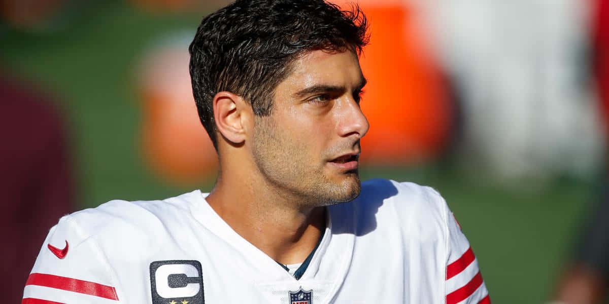 San Francisco 49ers Quarterback, Jimmy Garoppolo, In Action On The Field Wallpaper