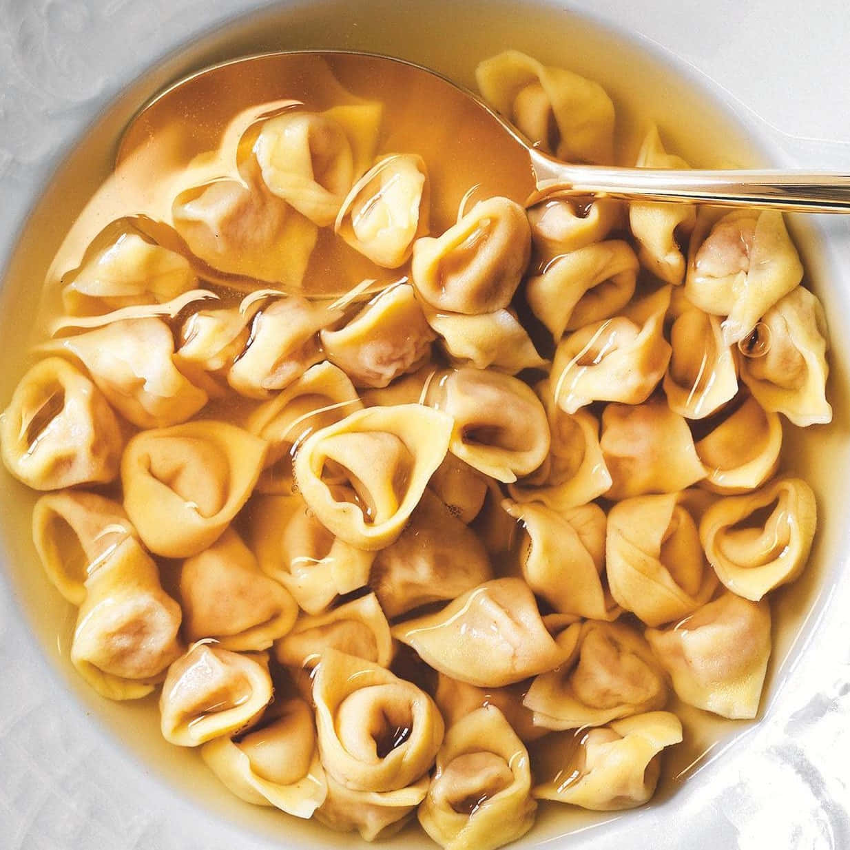 Savory And Freshly Prepared Tortellini In Brodo In Action Wallpaper