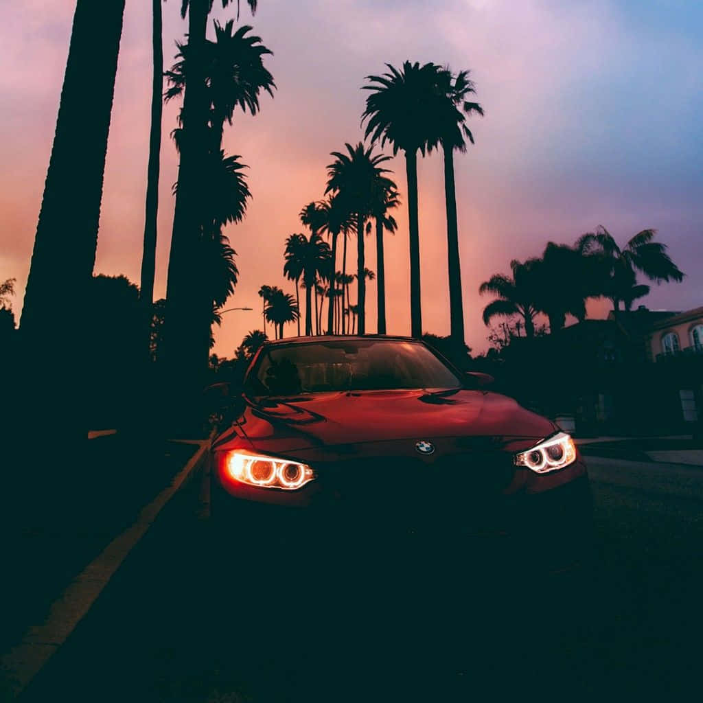 Scenic Sunset Drive Under An Orange Sky Wallpaper