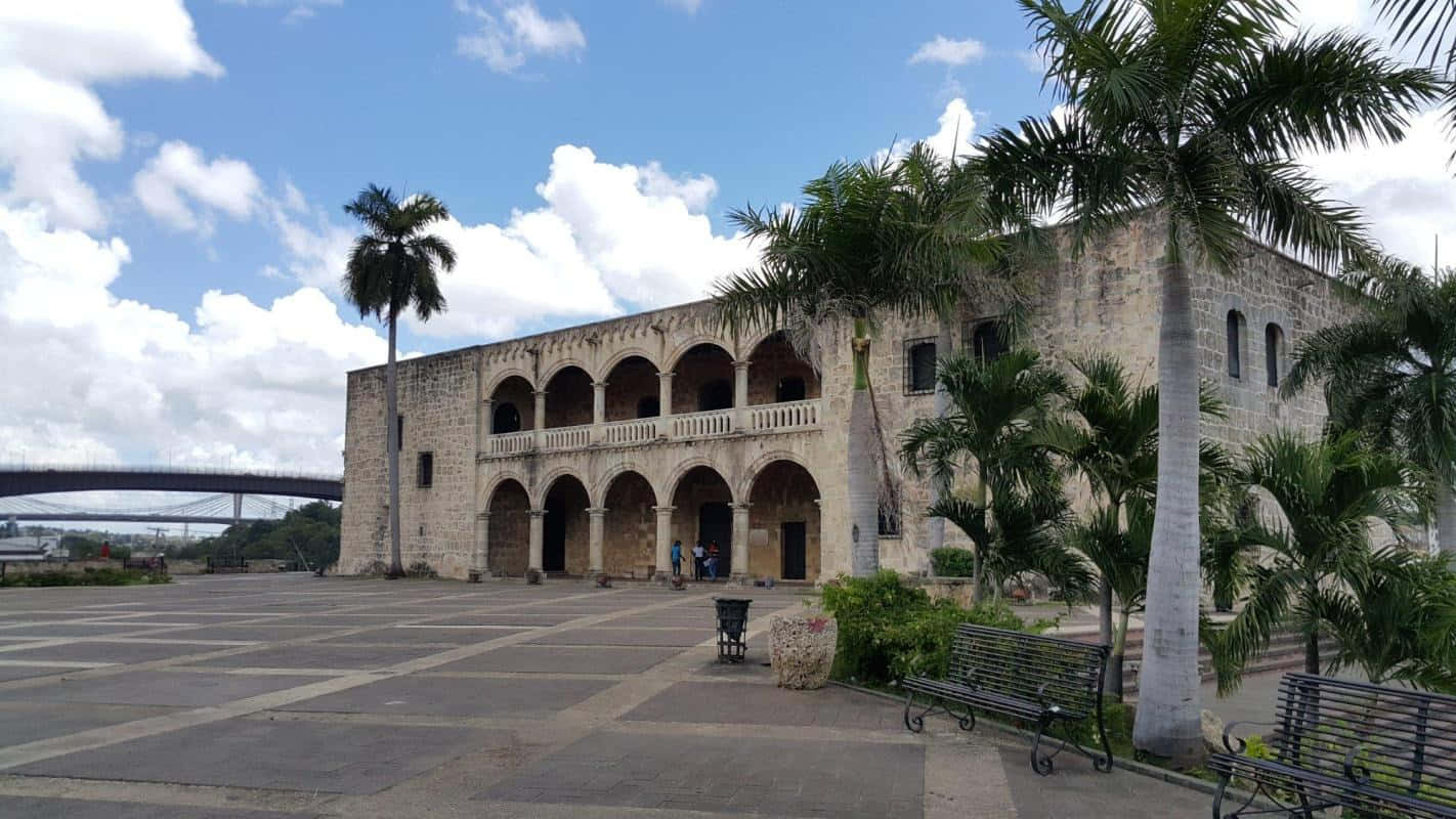 Scenic View Of Alcazar De Colon Under A Serene Blue Sky. Wallpaper