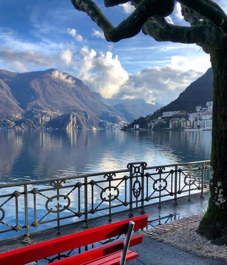 Scenic View Of Lugano Cityscape With Lake Lugano And Mountains Wallpaper