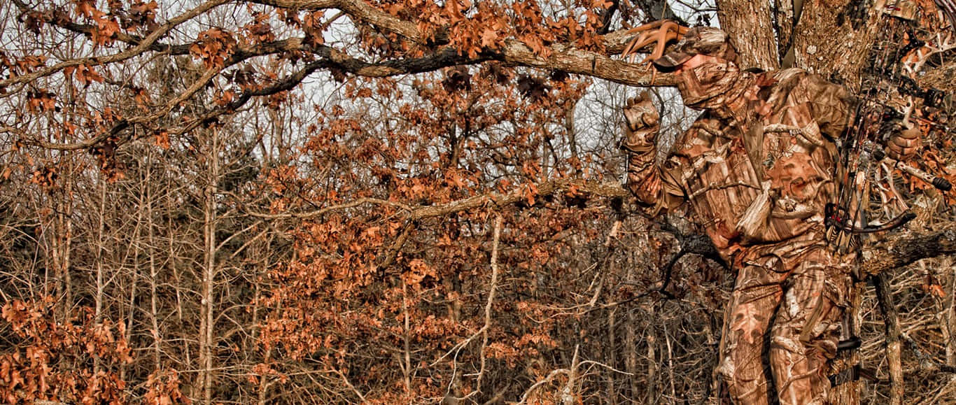 Selective Focus Shot Of A Hunter In Premium Hunting Camouflage Wallpaper