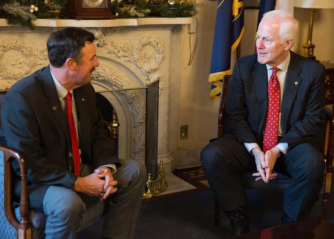 Senator John Cornyn In Discussion With A Bearded Man Wallpaper