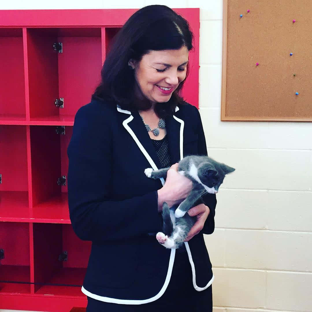 Senator Kelly Ayotte Playing With A Loving Cat. Wallpaper