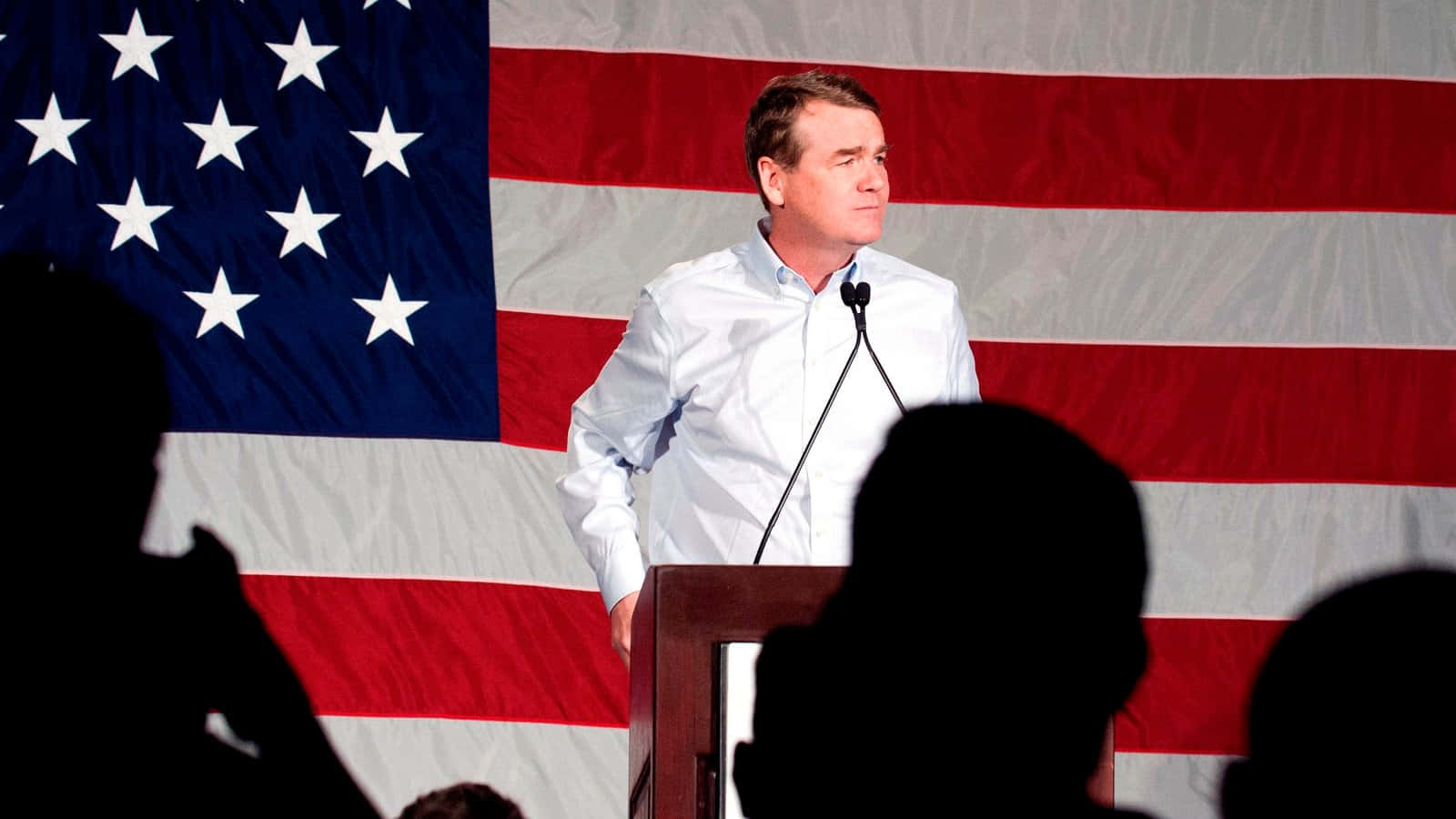 Senator Michael Bennet Stands With An American Flag Wallpaper