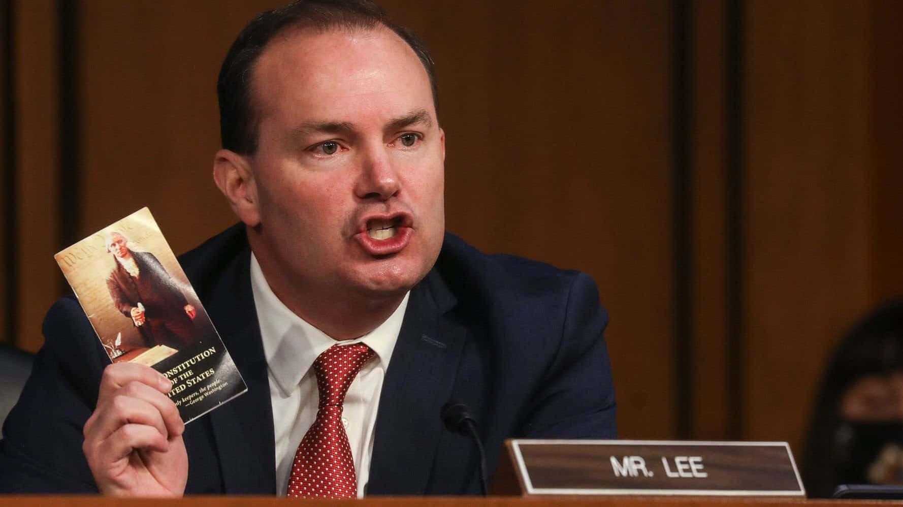 Senator Mike Lee Holding Constitution Book Wallpaper