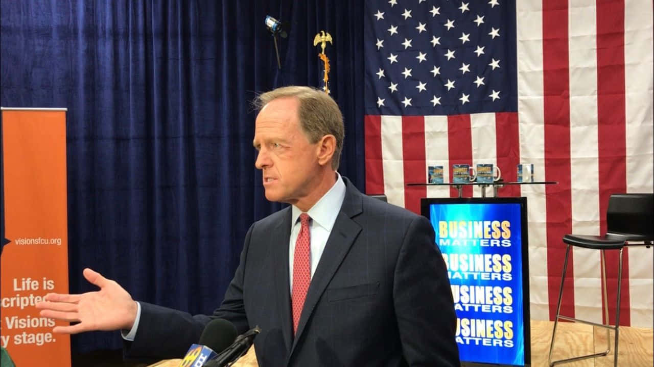 Senator Pat Toomey Speaking At A Business Event Wallpaper