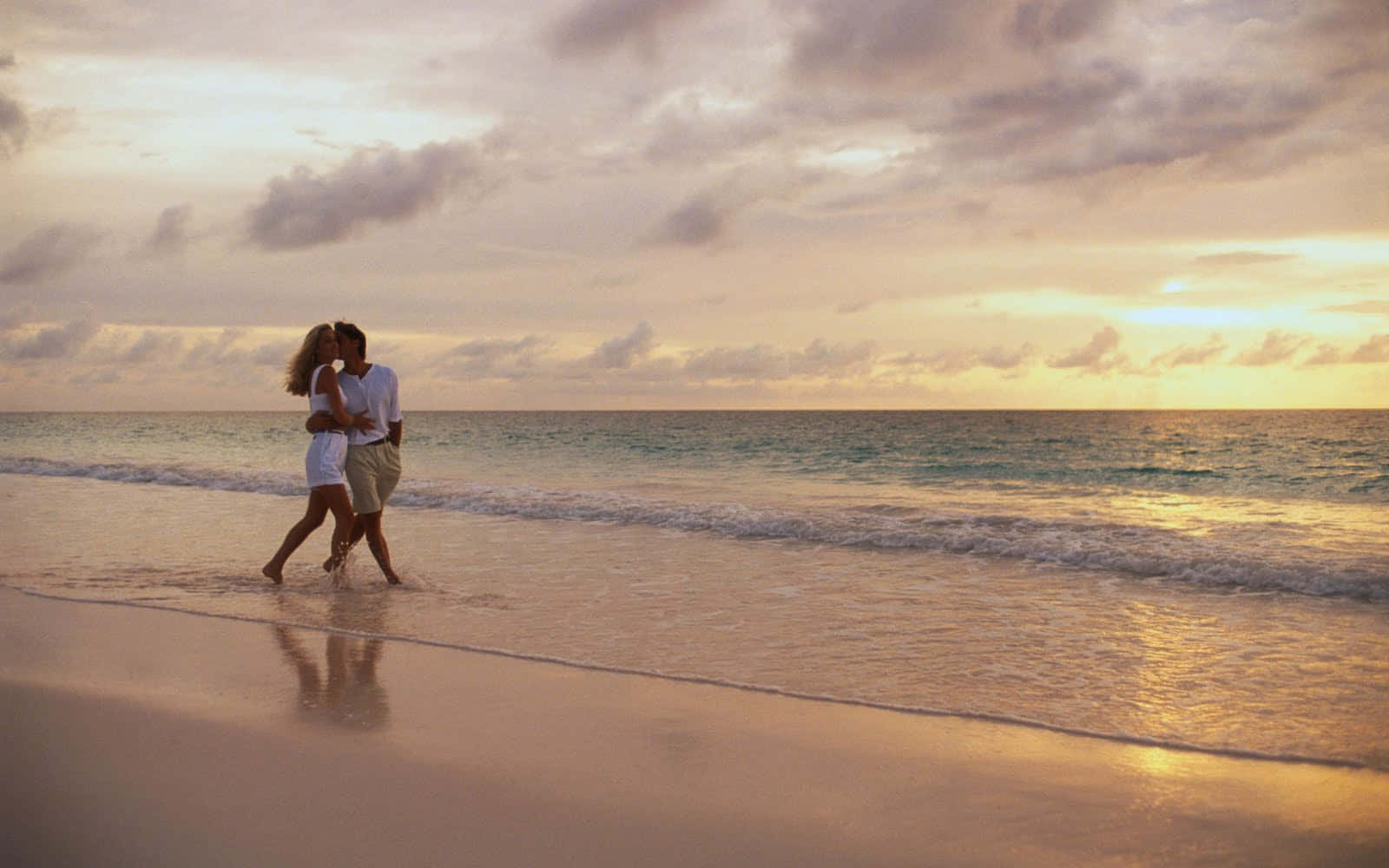 Serene Beach Walk At Sunset Wallpaper