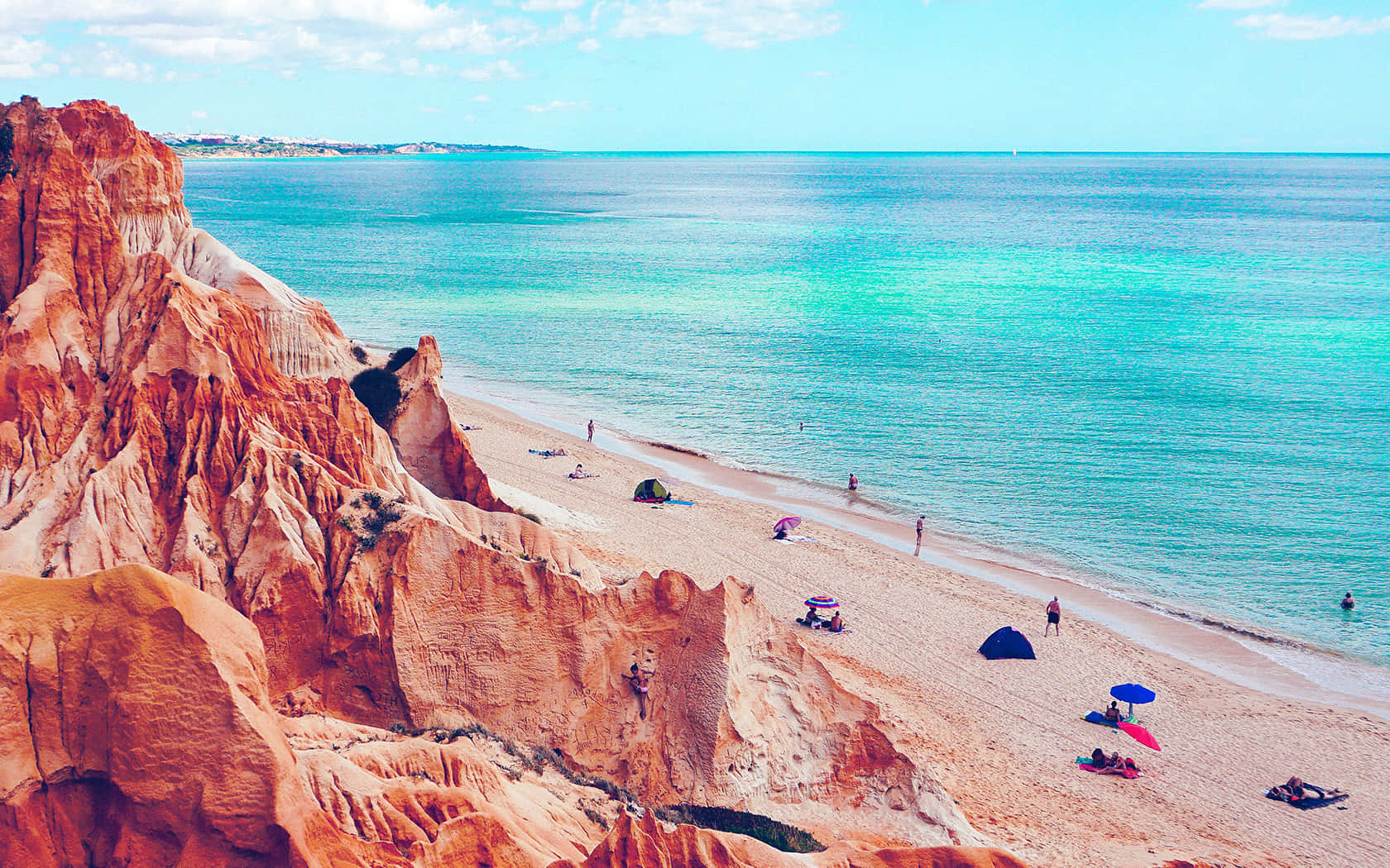 Serene Blue Watersand Golden Cliffs Beachscape Wallpaper