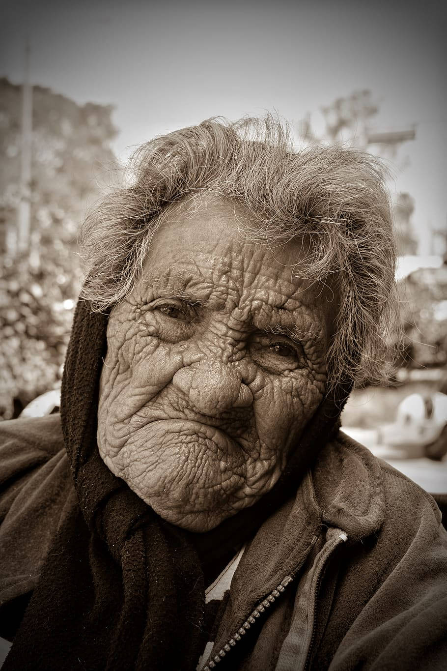 Serene Elderly Woman With A Thoughtful Expression Wallpaper