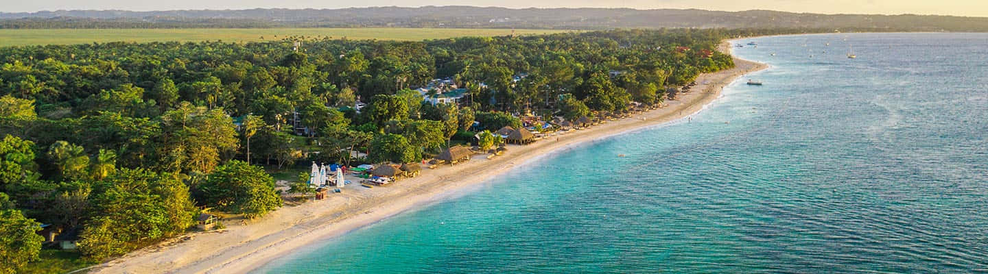 Serene Jamaican Beach At Sunset Wallpaper