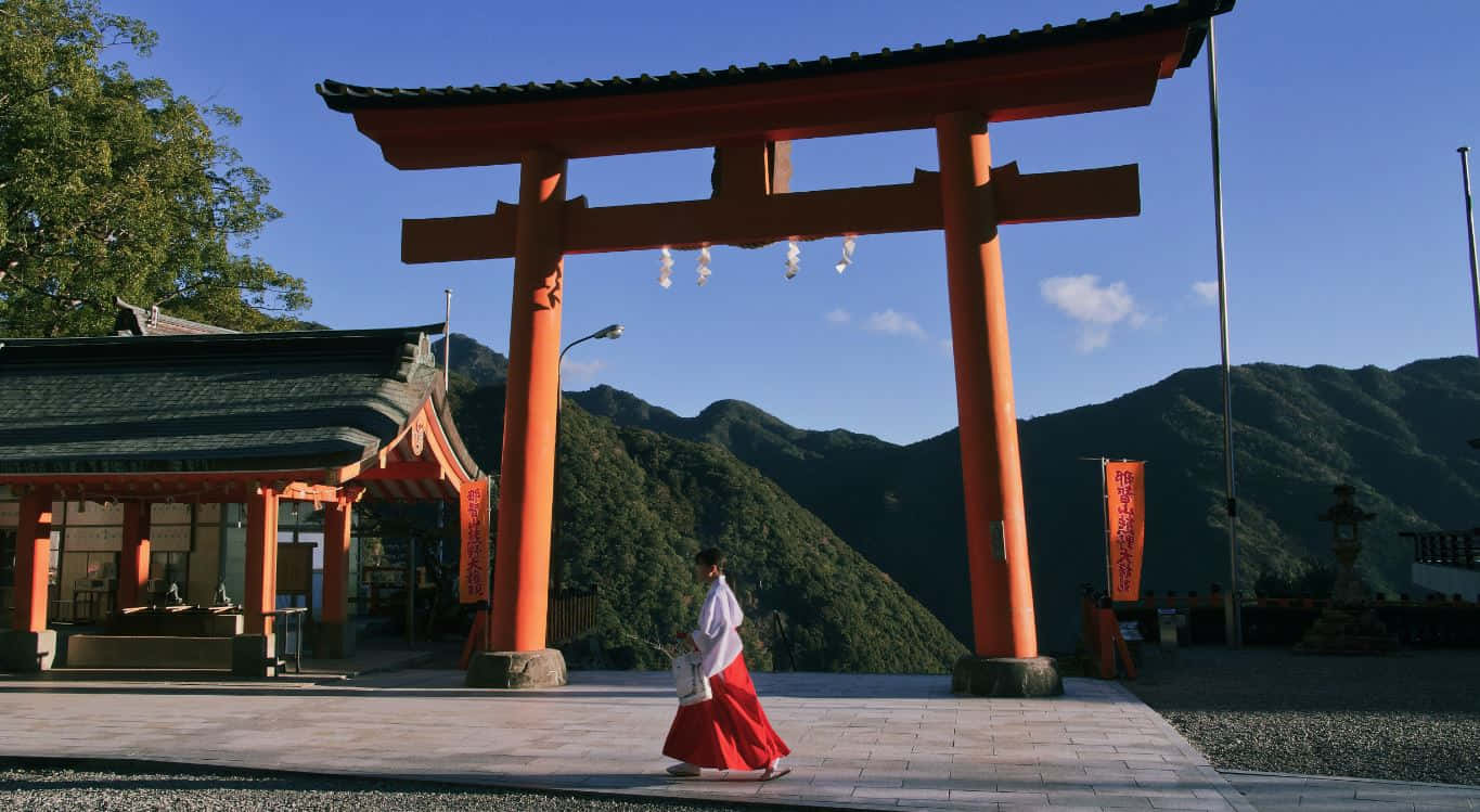 Serene Shinto Shrine Surrounded By A Lush Forest Wallpaper