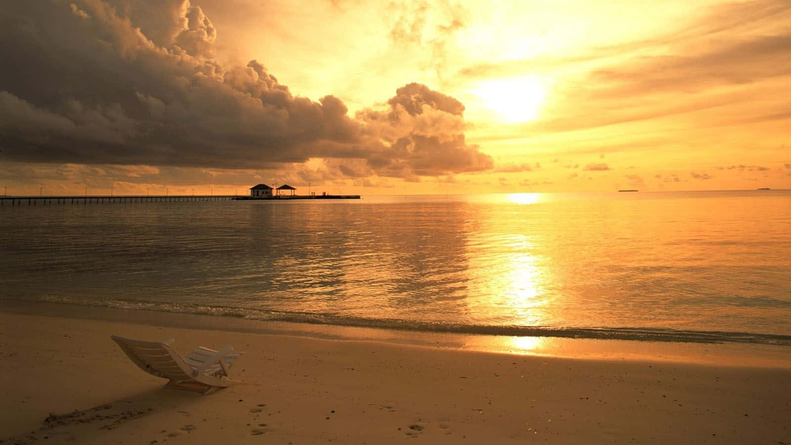 Serene Yellow Beach At Sunset Wallpaper