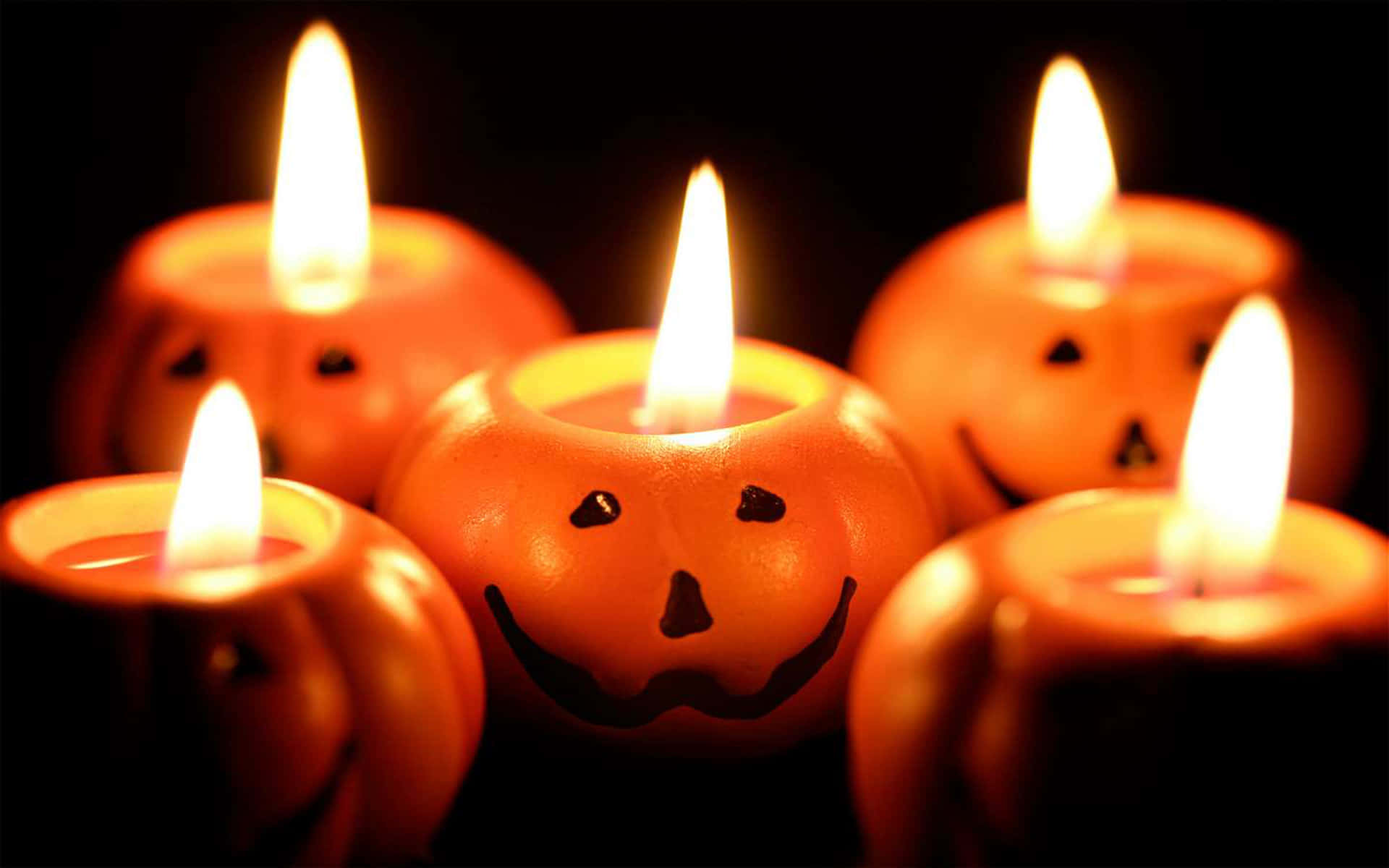 Set The Mood With Spooky Halloween Candles Wallpaper