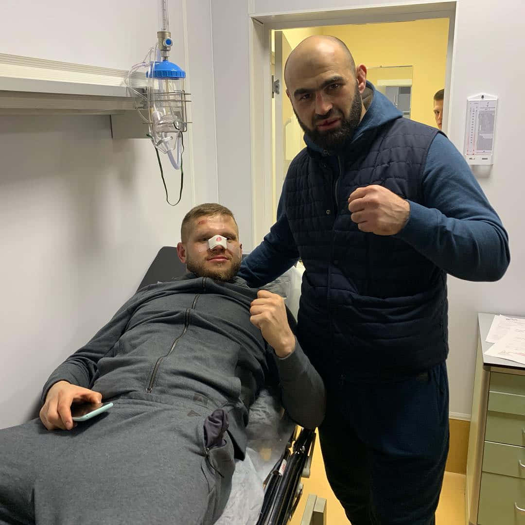 Shamil Abdurakhimov With Marcin Tybura On Stretcher Wallpaper