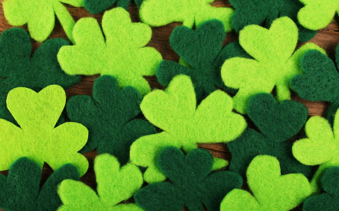 Shamrock Felt Leaves On A Wooden Table Wallpaper