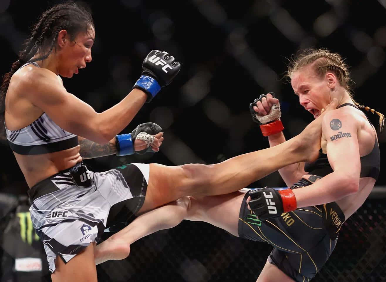 Shevchenko And Taila Santos Kicking Each Other Wallpaper