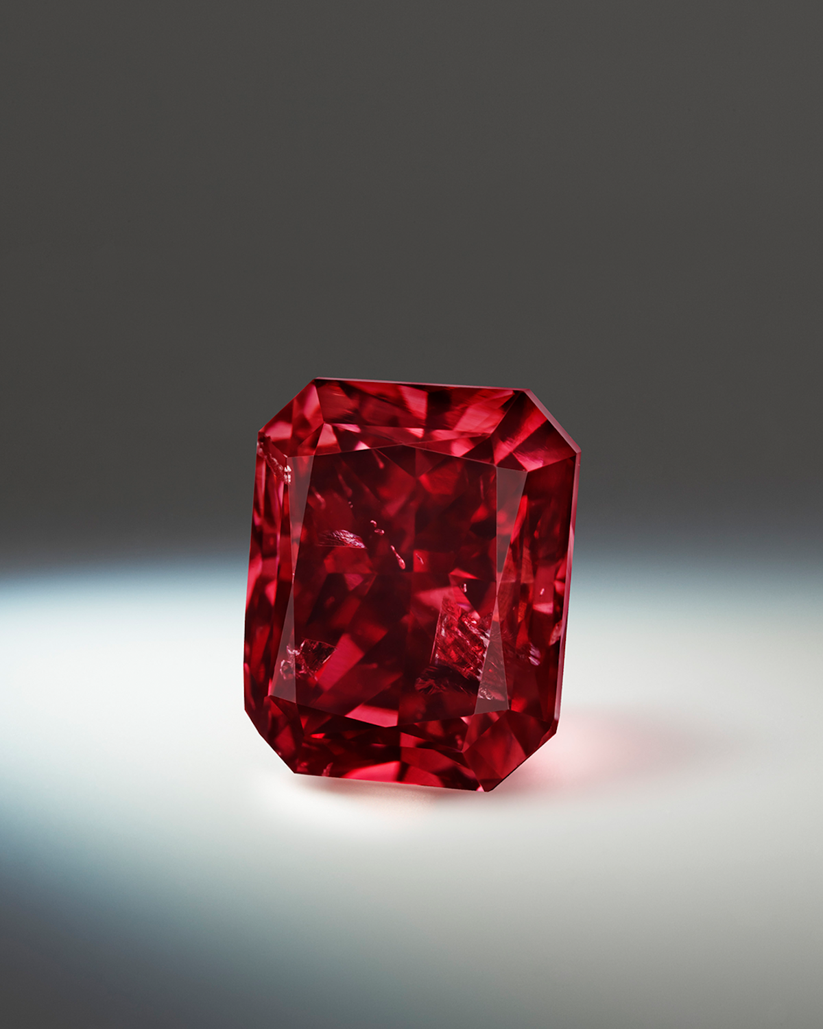 Shimmering Red Diamond Against A Dark Backdrop Wallpaper