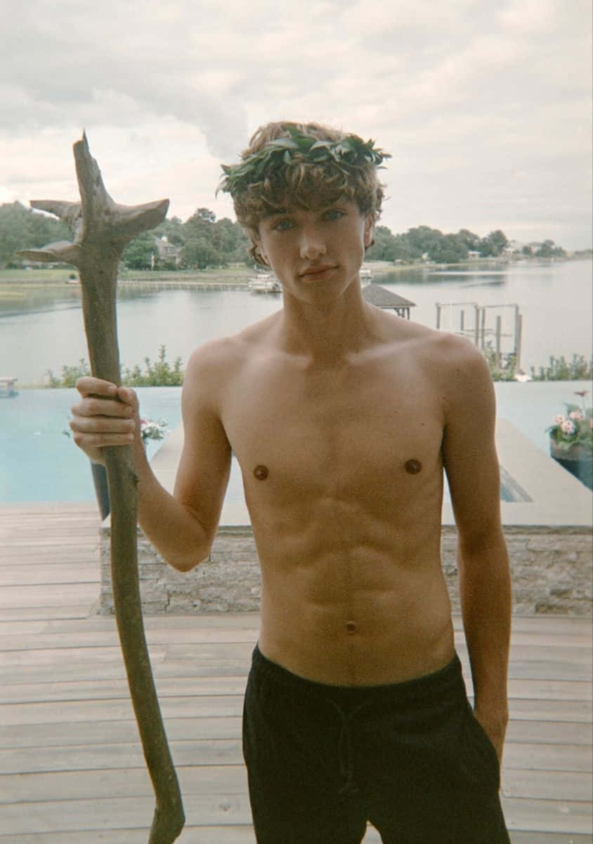 Shirtless Young Man With Staffand Laurel Wreath Wallpaper