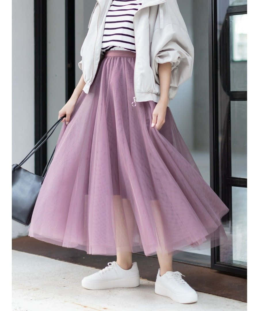 Show Off Your Flirty Style With Brightly Coloured Purple Skirt Wallpaper