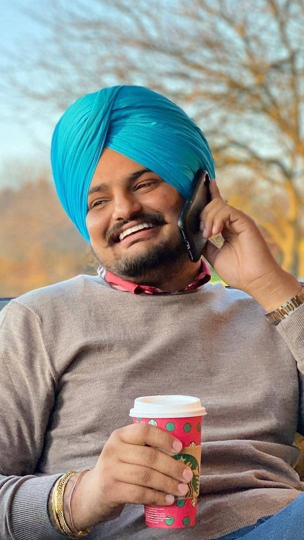 Sidhu Moose Wala Enjoying Starbucks Coffee Wallpaper