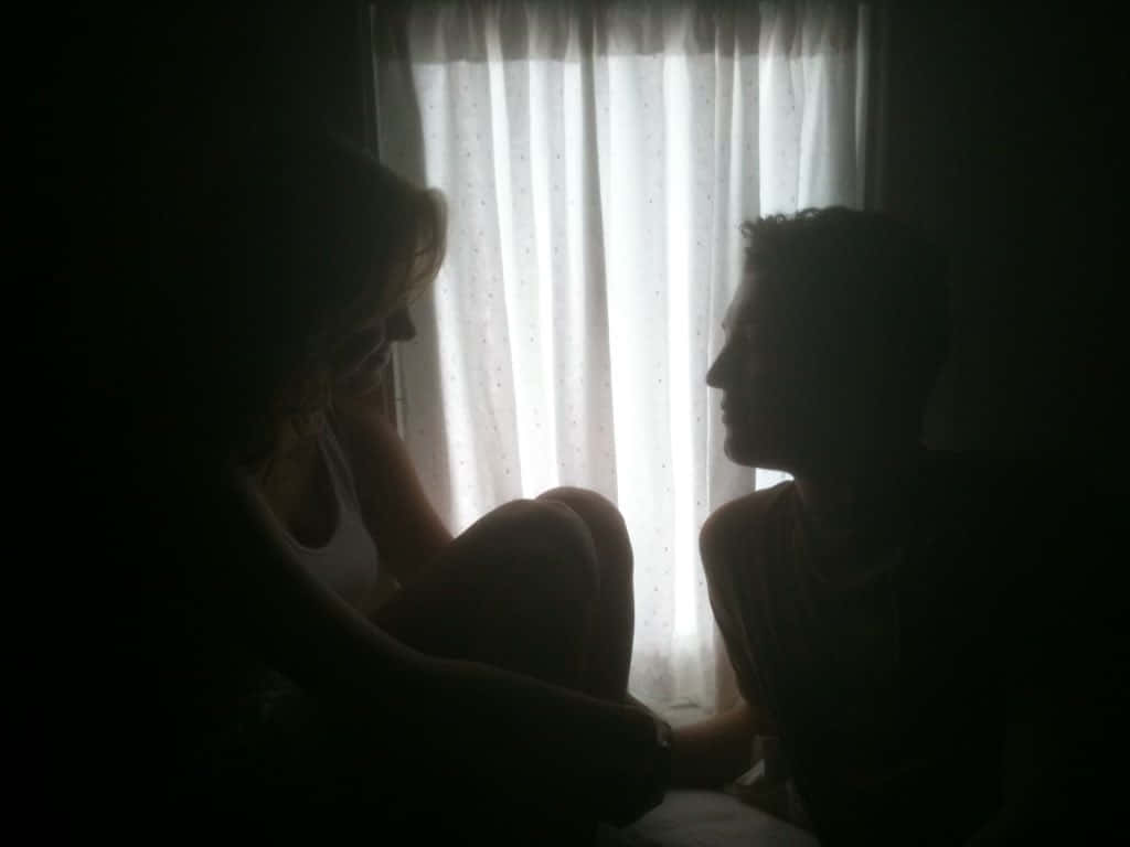 Silhouetted Teen Couple Window Wallpaper