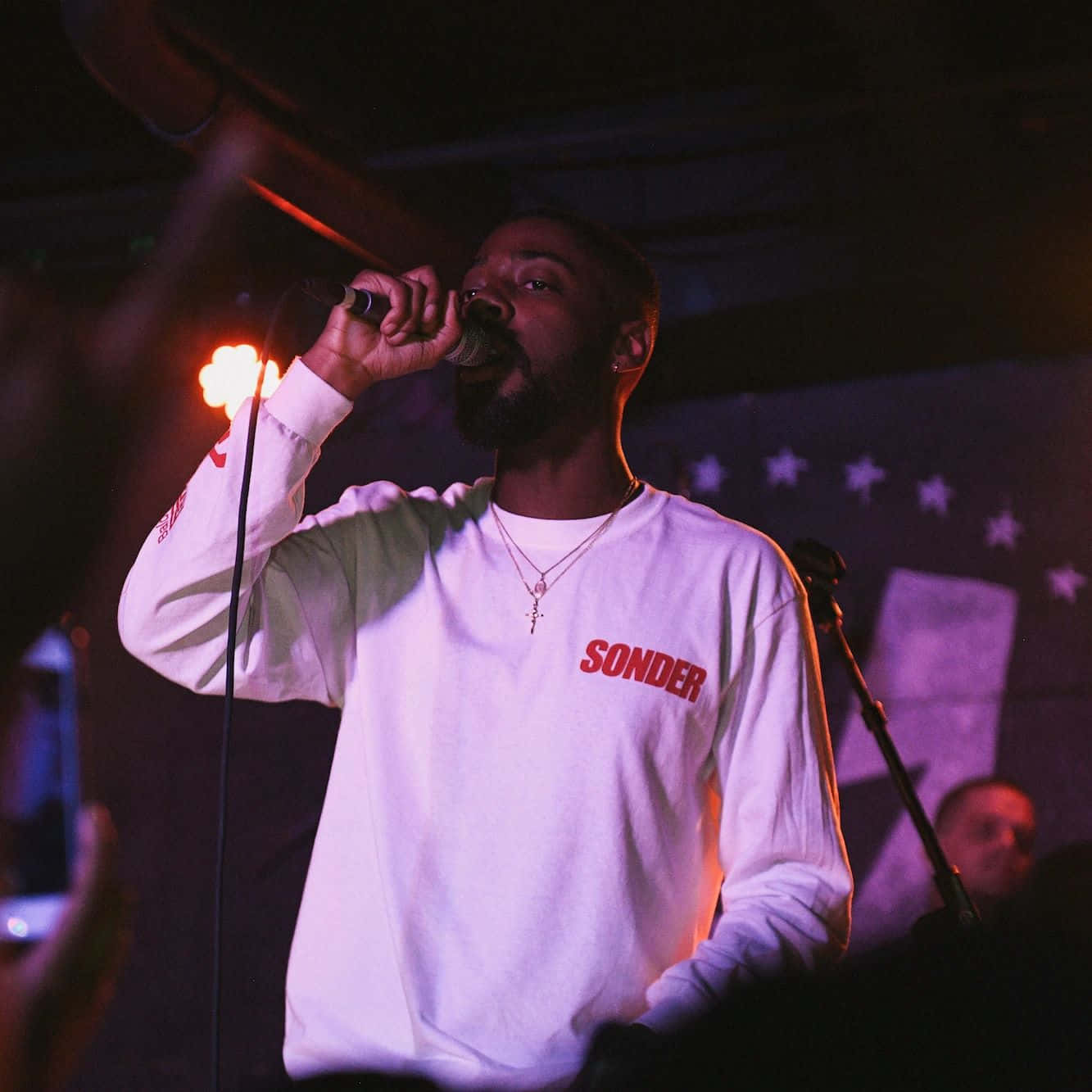 Singer Performance Under Red Lights Wallpaper