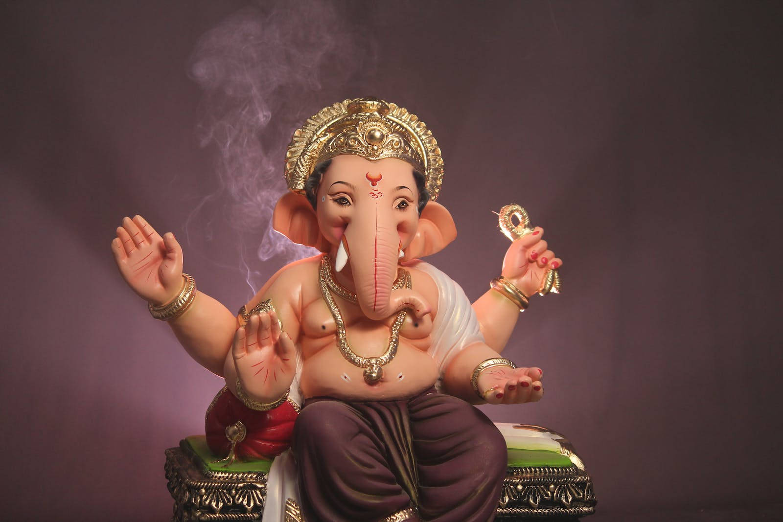 Sitting Vinayaka With Four Hands Wallpaper