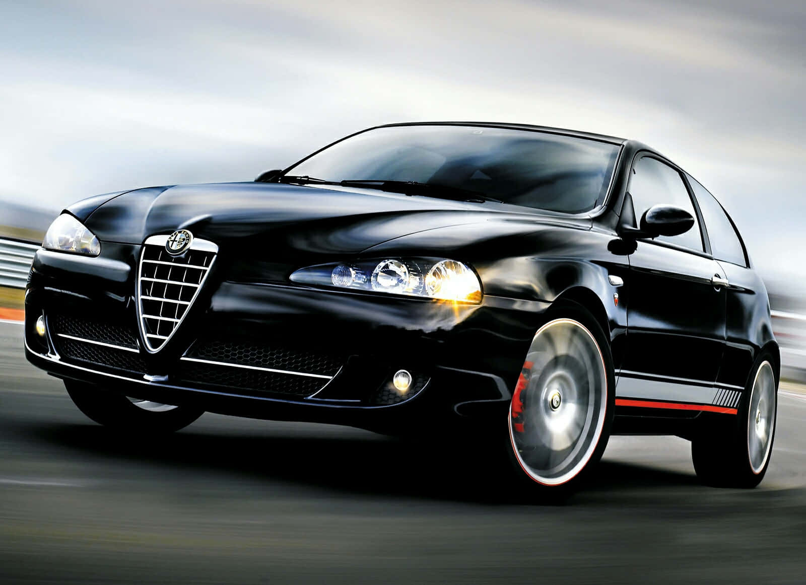 Sleek Alfa Romeo 147 On A Scenic Road Wallpaper