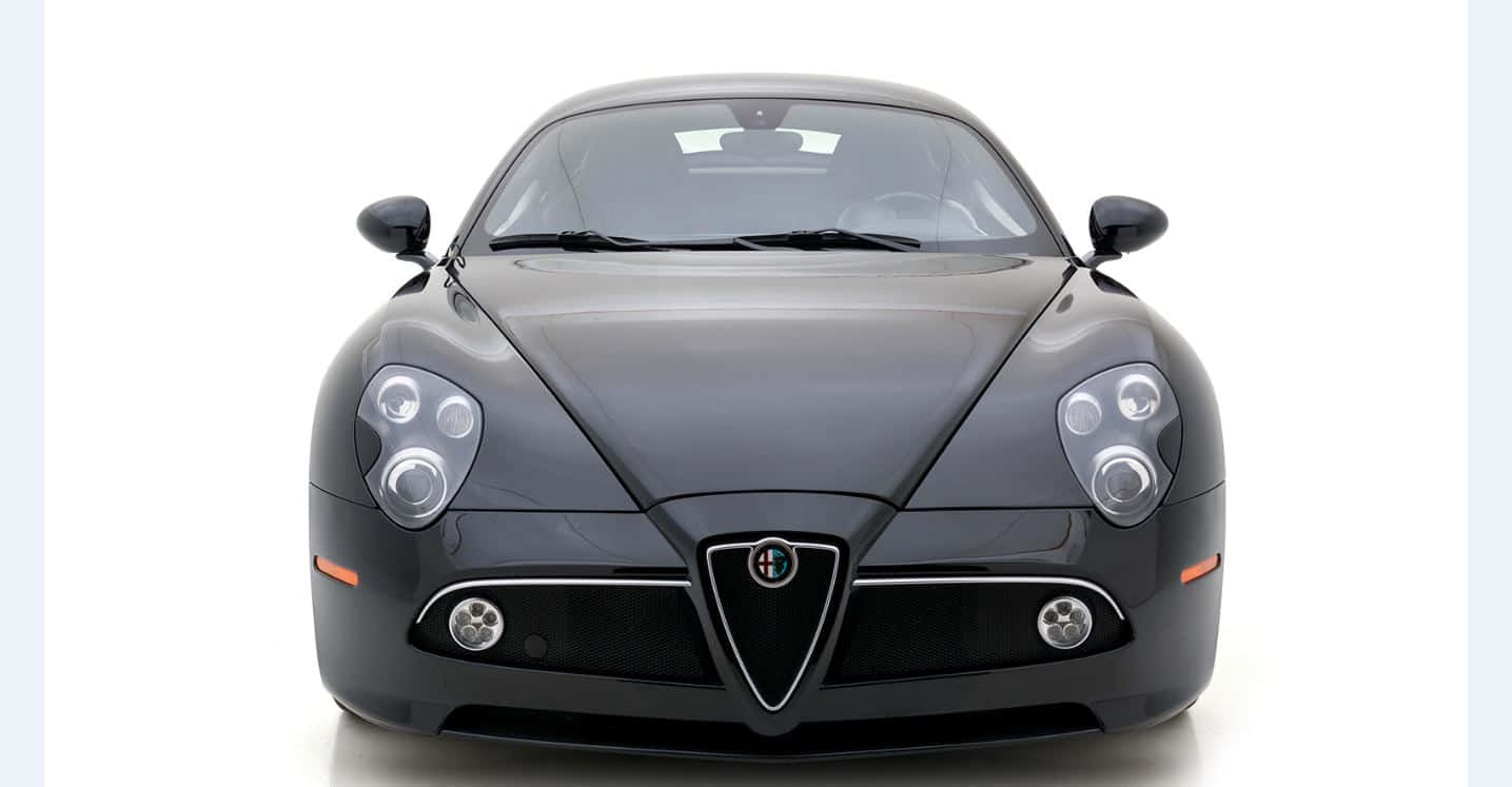 Sleek Alfa Romeo 8c Competizione Cruising The Streets Wallpaper