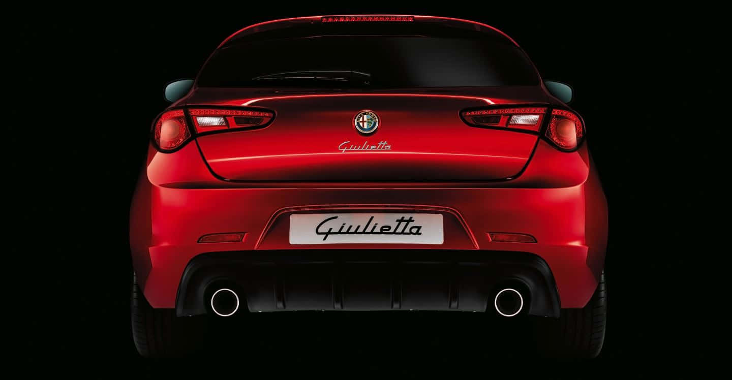 Sleek Alfa Romeo Giulietta On The Open Road Wallpaper