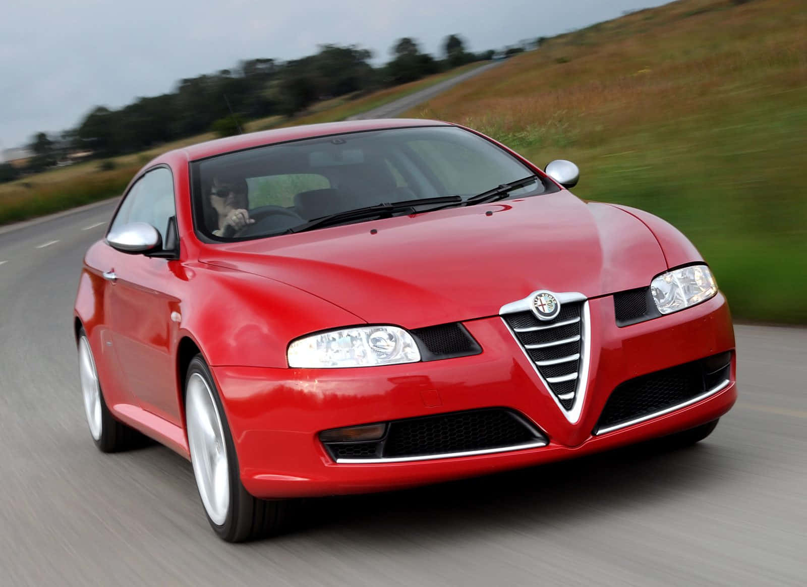 Sleek Alfa Romeo Gt Cruising On Open Road Wallpaper