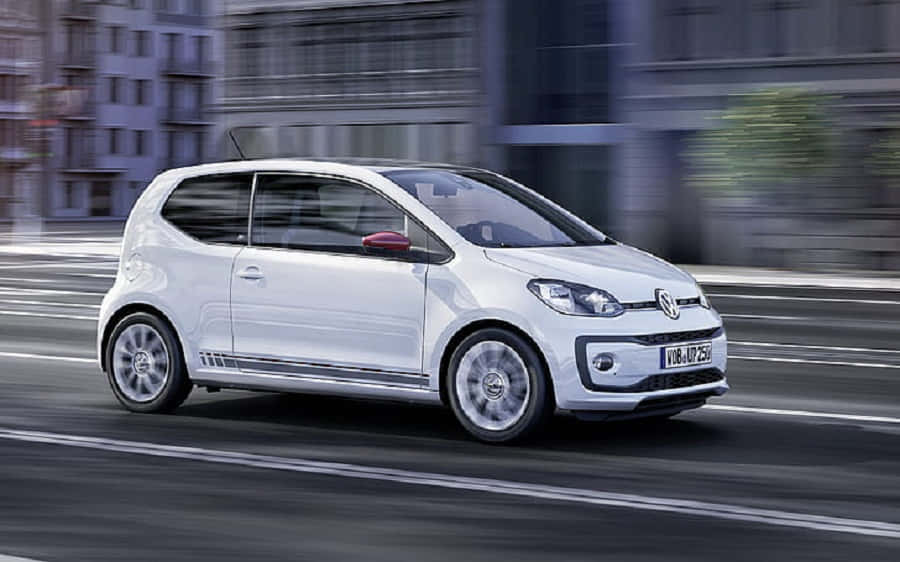 Sleek And Compact Volkswagen Up In Cityscape View Wallpaper