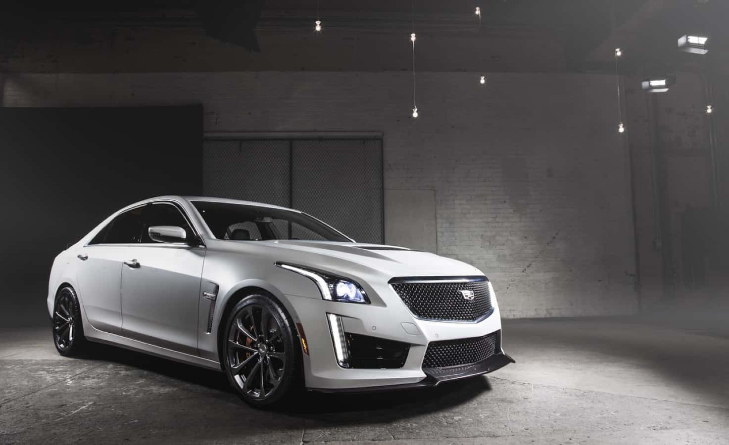 Sleek And Luxurious Cadillac Cts Standing Out On The Street In Nighttime Wallpaper