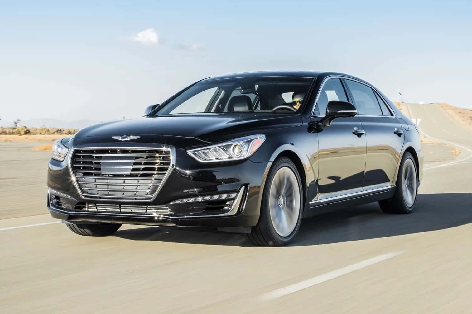 Sleek And Luxurious Genesis G90 Cruising Down The Road Wallpaper